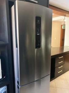 a stainless steel refrigerator in a kitchen at Apartamento Quinta da Serra - Canela in Canela