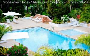 a swimming pool with chairs and umbrellas at Casa Lilu Playa Migjorn - Formentera Natural in Playa Migjorn