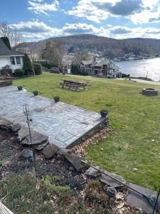 a park with a picnic table and a bench in the grass at Charming & Cozy - Breathtaking Lake & Sunset Views in Harveys Lake