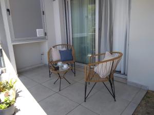 two chairs and a table on a balcony at Dpto Alberdi in Santa Fe