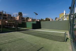 a tennis court with a net on top of it at Beach Duplex with Sea views in Málaga