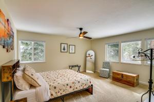 a bedroom with a bed and windows at Serene Nevada Retreat with Deck, Grill and Hot Tub! in Stateline