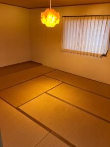 un salon vide avec un lustre et une chambre avec dans l'établissement Minshuku Miyoshi - Vacation STAY 14454v, à Echizen