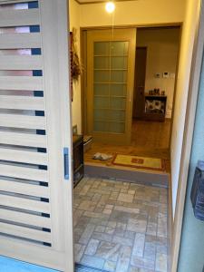 a door leading into a room with aoyer with a floor at Minshuku Miyoshi - Vacation STAY 14454v in Echizen