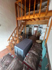 a room with a bunk bed and a staircase at ALCAZABA CON VISTAS INCREIBLES in Sierra Nevada