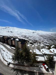 a city with a snow covered mountain in the background at ALCAZABA CON VISTAS INCREIBLES in Sierra Nevada