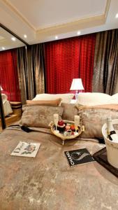 a bedroom with a large bed with red curtains at Sentral modern design leilighet med 2 soverom, gratis parkering in Oslo