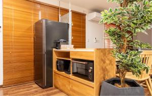 a kitchen with a stainless steel refrigerator and a counter at Residential Voyan Minamisunacho - Vacation STAY 14988v in Tokyo