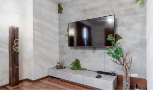 a living room with a television on a wall at Residential Voyan Minamisunacho - Vacation STAY 14988v in Tokyo