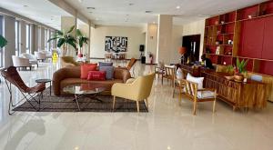 a lobby with a couch and chairs and a table at Flow Hotel Benguela in Benguela