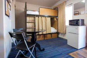 a small room with a table and a bunk bed at RAD Hostel in Colorado Springs