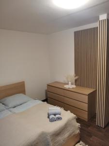 a bedroom with a bed with two towels on it at Klatovy Apartment in Klatovy