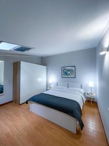 a bedroom with a large bed with blue walls at RESIDENCE VIOLA in Foggia +9 photos