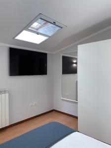 a living room with a skylight and a television at RESIDENCE VIOLA in Foggia