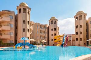 a pool at a resort with a water slide at Marom Port Said Resort in Port Said