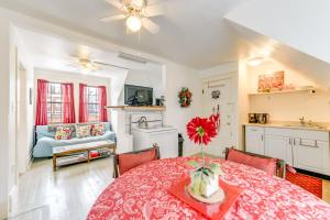 a kitchen and a dining room with a table with a flower on it at Cozy Niagara Falls Cottage with Gas Grill and Patio! in Niagara Falls
