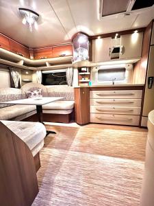 an rv with a kitchen and a living room at Caravanas Con Encanto El Palmar in El Palmar