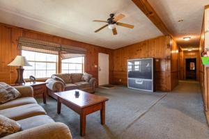 a living room with a couch and a tv at 6 Guests 3br, Fully Furnished, On-site Enjoyment in Neillsville