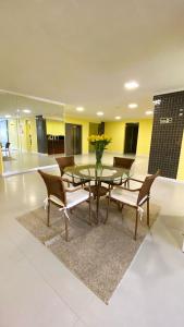 a dining room with a glass table and chairs at ÓPER SMART HOTEL in Santa Maria