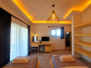 Zimmer mit 2 Betten und einem Schreibtisch mit einem Computer in der Unterkunft Palamut Butik Otel in Datca