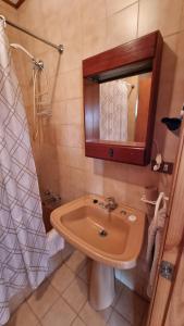 a bathroom with a sink and a mirror at Cabañas Brisas Del Lago in Puerto Varas +15 photos