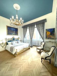 a bedroom with a bed and a chandelier at Stile Libero Guest House in Turin