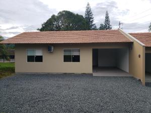 a house with a garage in front of it at Casa Completa da Magui - 02 in Pomerode