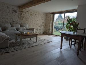 a living room with a couch and a table at Le Terrier in Mercuès