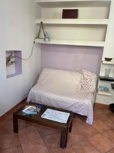 a small bedroom with a bed and a table at Dimora Ghirlandaio in Florence