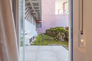 a glass door leading to a bathroom with a yard at CMDreams Gold- Apartamentos turísticos con ruinas romanas en el centro de Mérida in Merida