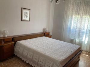 a bedroom with a bed and a window at Casa Rina in Livorno