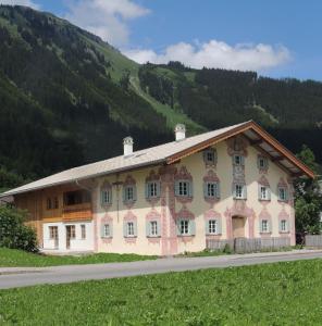 a large building in front of a mountain at Residenz 111 in Holzgau