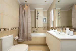 a bathroom with a toilet and a sink and a tub at Kiss-ammos Apartments in Kissamos +34 photos
