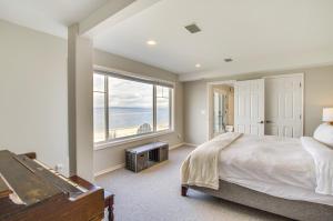 a bedroom with a bed and a large window at Bright Camano Home about 4 Mi to Cama Beach State Park in Camano