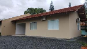 a house with two garage doors in front of it at Casa Completa da Magui - 01 in Pomerode
