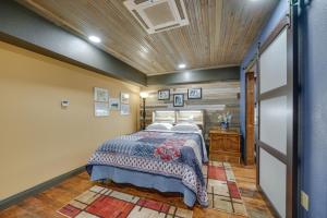 a bedroom with a bed and a wooden ceiling at Central Texarkana Studio Rental with Railroad Views! in Texarkana