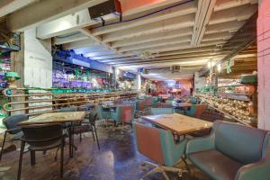 a restaurant with tables and chairs and a bar at Pet-Friendly Texarkana Studio in The Historic 1894 in Texarkana