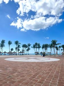 a large circle in the middle of a beach with palm trees at Apartamento Cadaques Bayahibe in Mata Chalupe