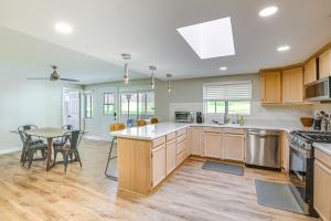 a kitchen with wooden cabinets and a table with chairs at Spacious El Cajon Home - Day Trip to San Diego! in El Cajon