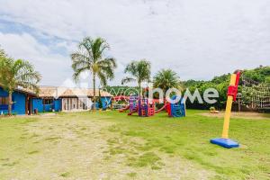 a playground in front of a house at Casa com piscina e mesa de sinuca em Itupeva in Itupeva