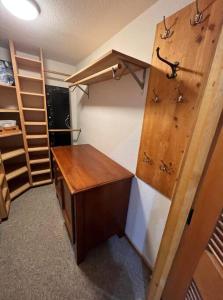 a small room with a wooden desk and shelves at Cedar Cabin Near Silverwood in Spirit Lake