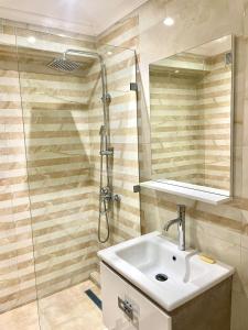 a bathroom with a sink and a shower at New Luxurious apartment Agdal Rabat center in Rabat