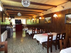 a dining room with tables and chairs and a kitchen at Sylwia in Szklarska Poręba +22 photos