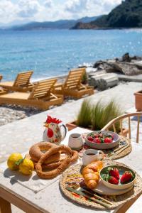 a table with food on it with a view of the ocean at Aegean Stories pelagos suites in Avlákia