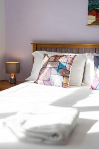 a white bed with a pillow and a lamp at Oak House in Mid Wales By Seren Short Stays in Machynlleth