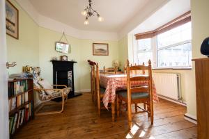 a dining room with a table and a fireplace at Oak House in Mid Wales with Log Burner By Seren Short Stays in Machynlleth