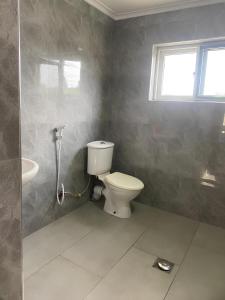 a bathroom with a toilet and a sink at Lema Luxe Villa - Bahari Beach, Dar Es Salam in Dar es Salaam