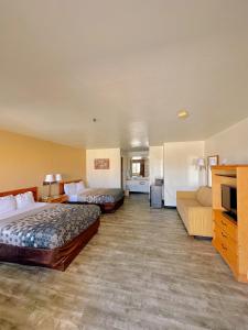 a hotel room with two beds and a couch at Econo Lodge Lordsburg I-10 in Lordsburg