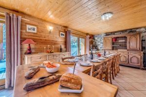 a kitchen with a long wooden table and chairs at Chalet Gypaete - Chalets pour 14 Personnes 881 in Tignes