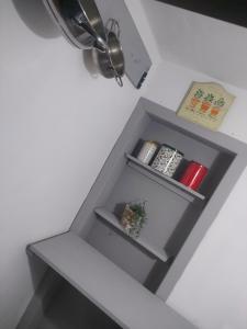 a grey shelf with a plant and a ceiling fan at La casa di Noah in Montecatini Terme